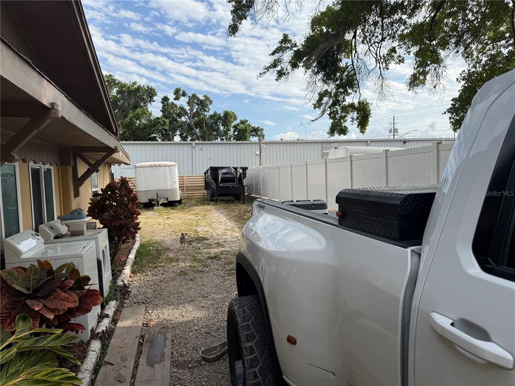 A white pickup truck is parked next to a house with outdoor laundry appliances — 4106 W SOUTH AVENUE, TAMPA, FL