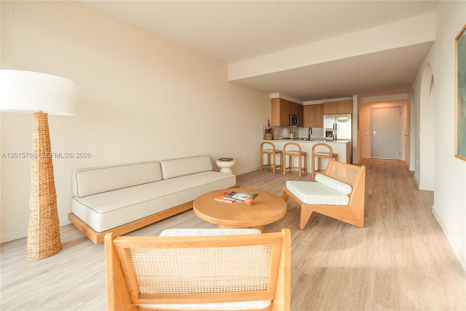 A living room with a sofa, two chairs, and a coffee table faces an open kitchen — 275 SW 6th St # 5303, Miami FL 33130, MIAMI, FL