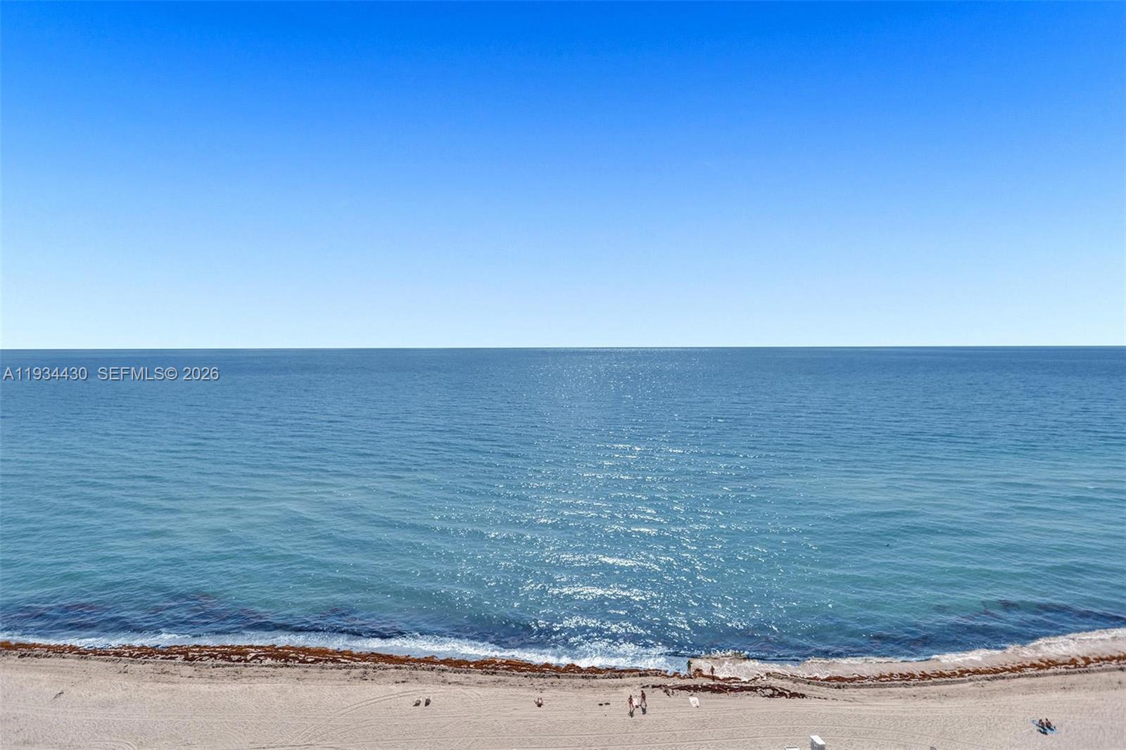 An elevated view of a sandy beach and the ocean under a clear sky — 6917 Collins Ave # 503, Miami Beach FL 33141, MIAMI BEACH, FL