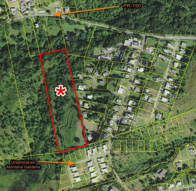 An aerial map shows a large, rectangular vacant lot outlined in red near a residential neighborhood — KM HM 17.7 CARR 150, COAMO, PR