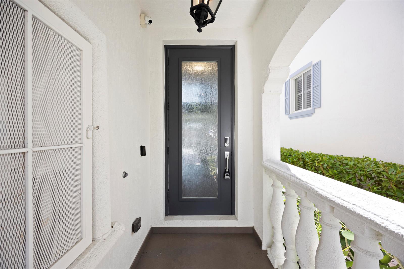 A dark gray front door with a glass panel sits under a covered entryway — 3055 Waterside Circle, Boynton Beach FL 33435, BOYNTON BEACH, FL