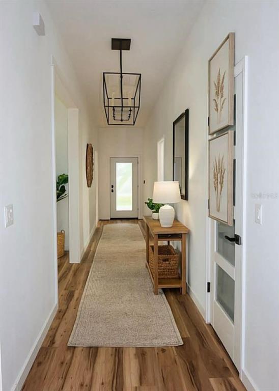 A bedroom with white walls, wood-look flooring, a ceiling fan, and a single window — 611 ELM STREET, SAFETY HARBOR, FL