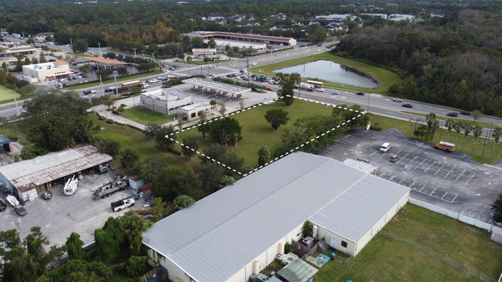 An aerial view shows a vacant grassy lot outlined with a dashed white line — 2700 W 25TH STREET UNIT Parcel B, SANFORD, FL