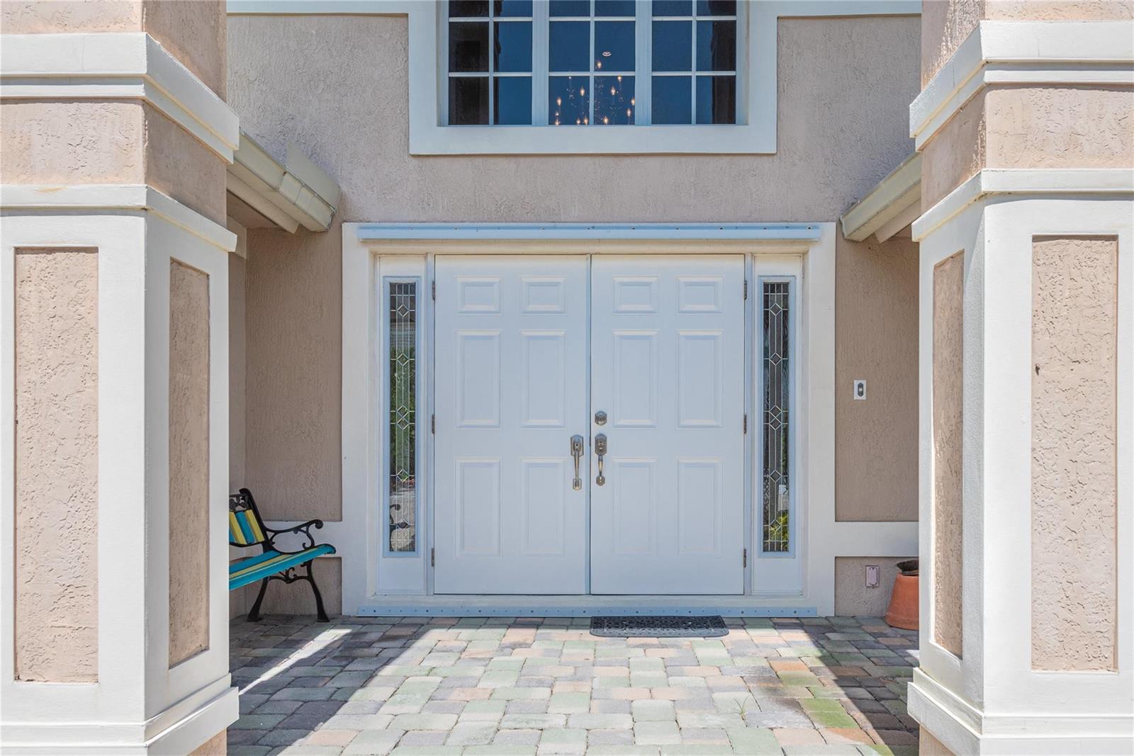 A double white front door with sidelights sits between two large columns on a patio — 2999 Banyan Road, Boca Raton FL 33432, BOCA RATON, FL