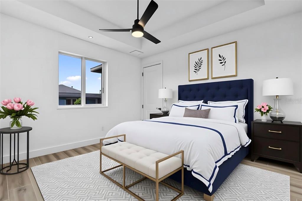 A bedroom features a blue tufted headboard, white bedding, a ceiling fan, and a window — 10071 KINGSVILLE DRIVE, PORT CHARLOTTE, FL