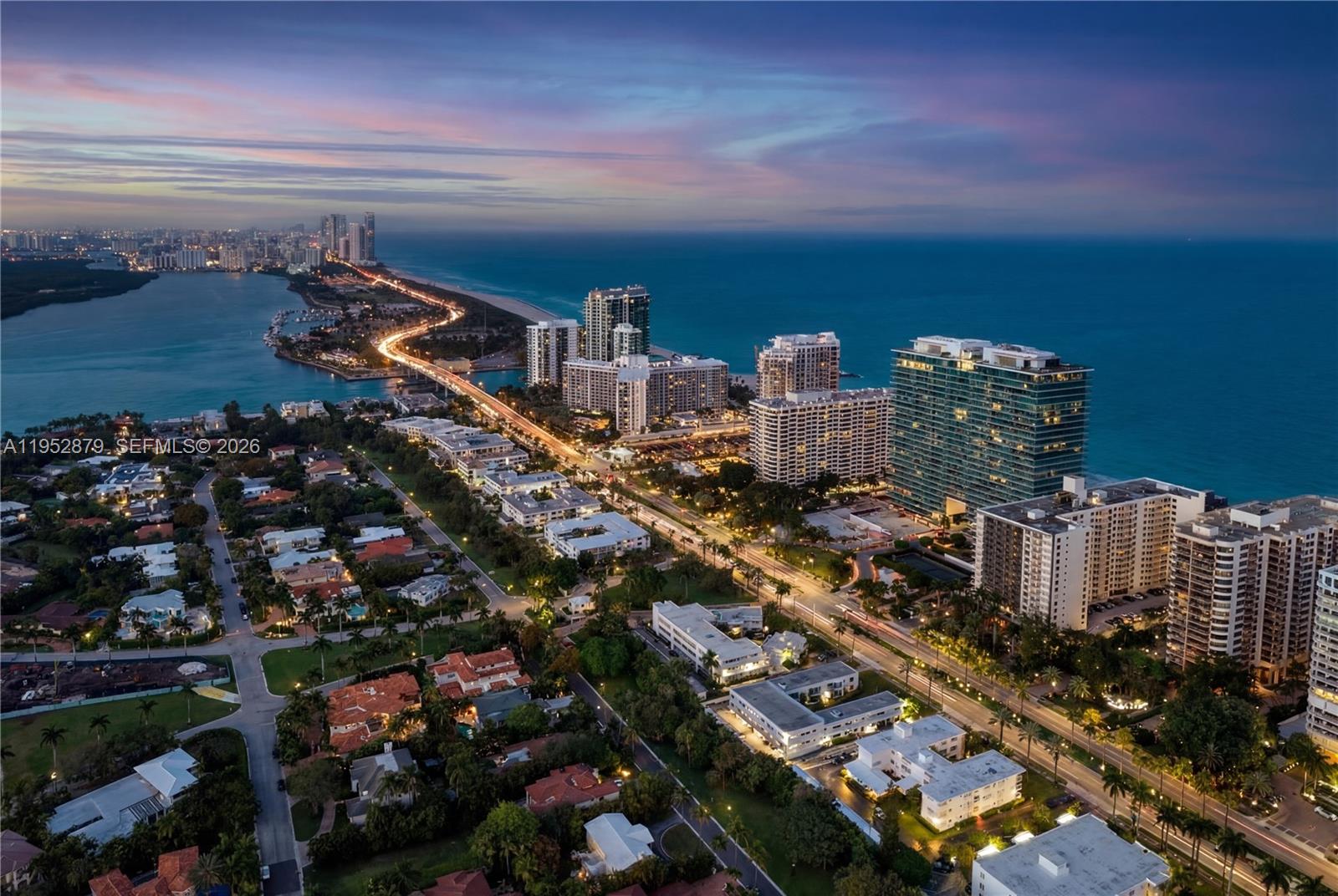 An aerial view shows a coastal city with high-rise buildings, residential homes, and a bridge — 10203 Collins Ave # 2701, Bal Harbour FL 33154, BAL HARBOUR, FL