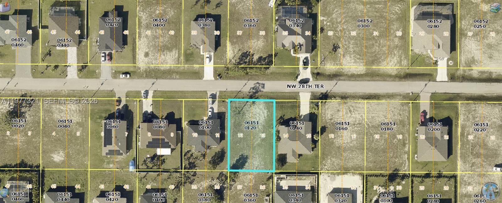 This is an aerial map showing a vacant residential lot highlighted in blue — 2424 NW 28, Cape Coral FL 33993, CAPE CORAL, FL