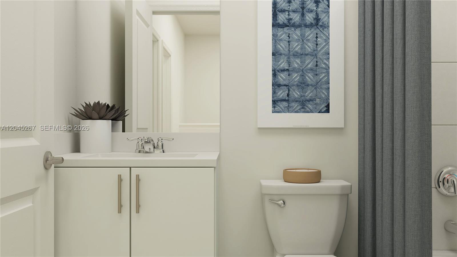 This bathroom features a white vanity, a toilet, and a framed blue patterned wall art — 1124 SE 3 ST, Florida City FL 33035, FLORIDA CITY, FL
