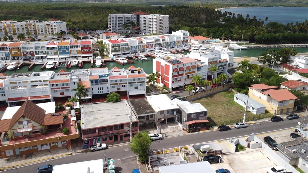 An aerial view shows a coastal residential complex with colorful townhouses, a marina, and surrounding streets — 47 Luis Munoz Rivera ST SR-101 POBLADO DE BOQUERON, CABO ROJO, PR