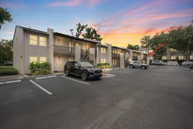 A multi-story apartment building exterior features a parking lot with several parked cars — 527 S LINCOLN AVENUE UNIT A208, TAMPA, FL
