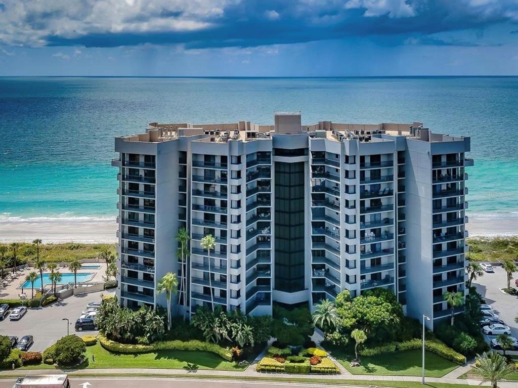A sign for Dan's Island stands in front of a tall residential building with balconies — 1660 GULF BOULEVARD UNIT PH1, CLEARWATER BEACH, FL