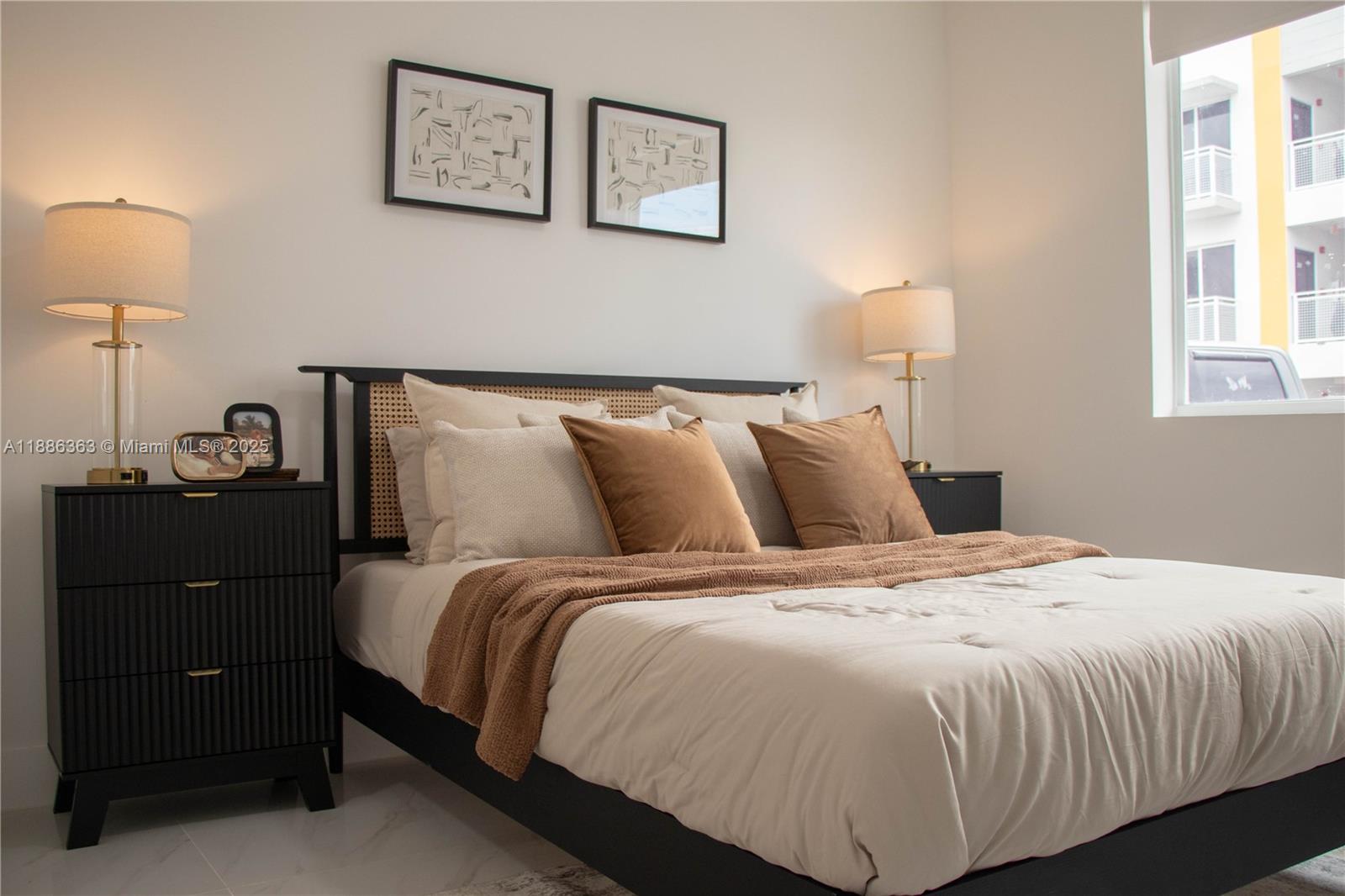 A bedroom features a black bed frame with cane detailing, two nightstands, and matching lamps — 1455 W 29th St # 113, Hialeah FL 33012, HIALEAH, FL