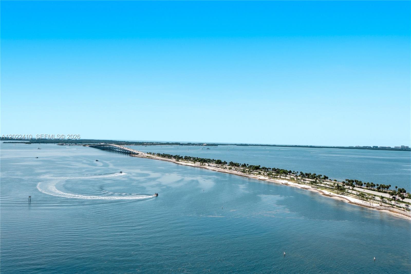 An aerial view shows a long bridge connecting to a narrow, palm-lined coastal road — 175 SE 25th Rd # 1604, Miami FL 33129, MIAMI, FL