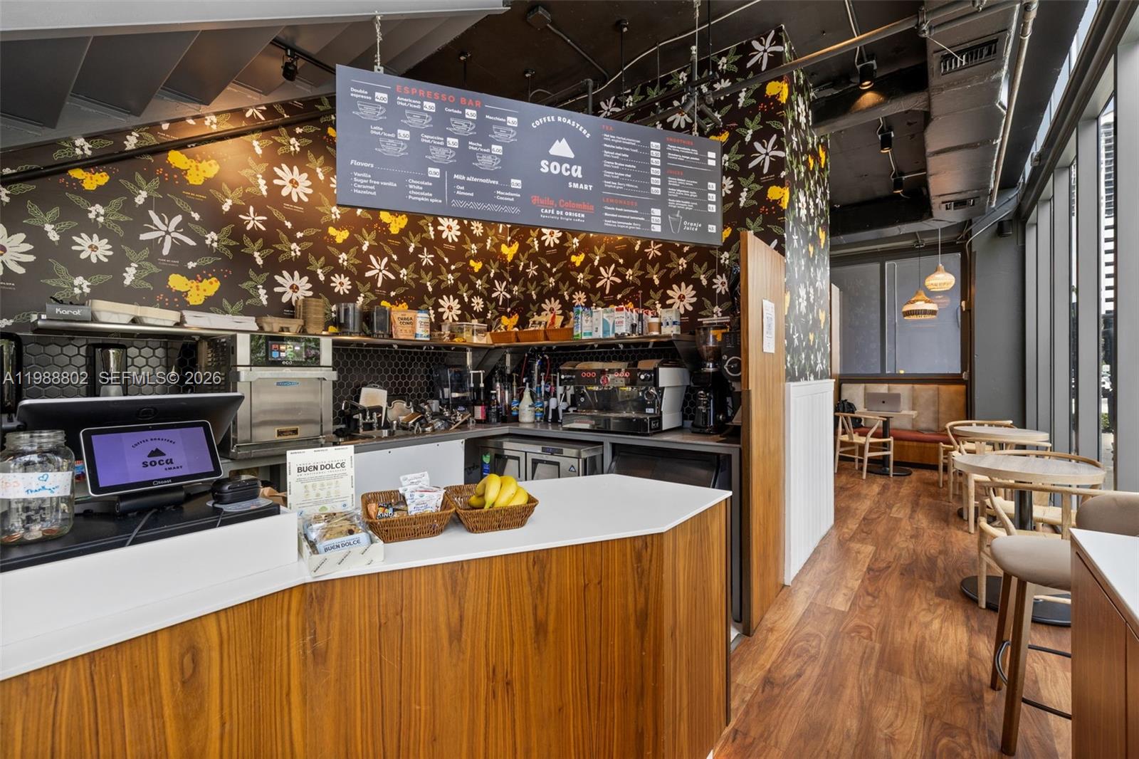 A coffee shop interior features a service counter, floral wallpaper, and wooden seating area — 239 SW 9th St # 101, Miami FL 33130, MIAMI, FL