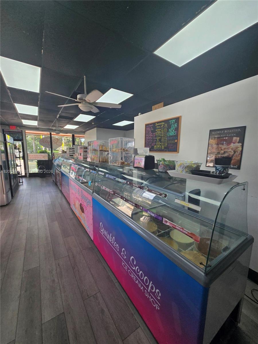 An ice cream shop interior features a long glass display case and a menu board — 899 E PALMETTO PARK RD, Boca Raton FL 33432, BOCA RATON, FL