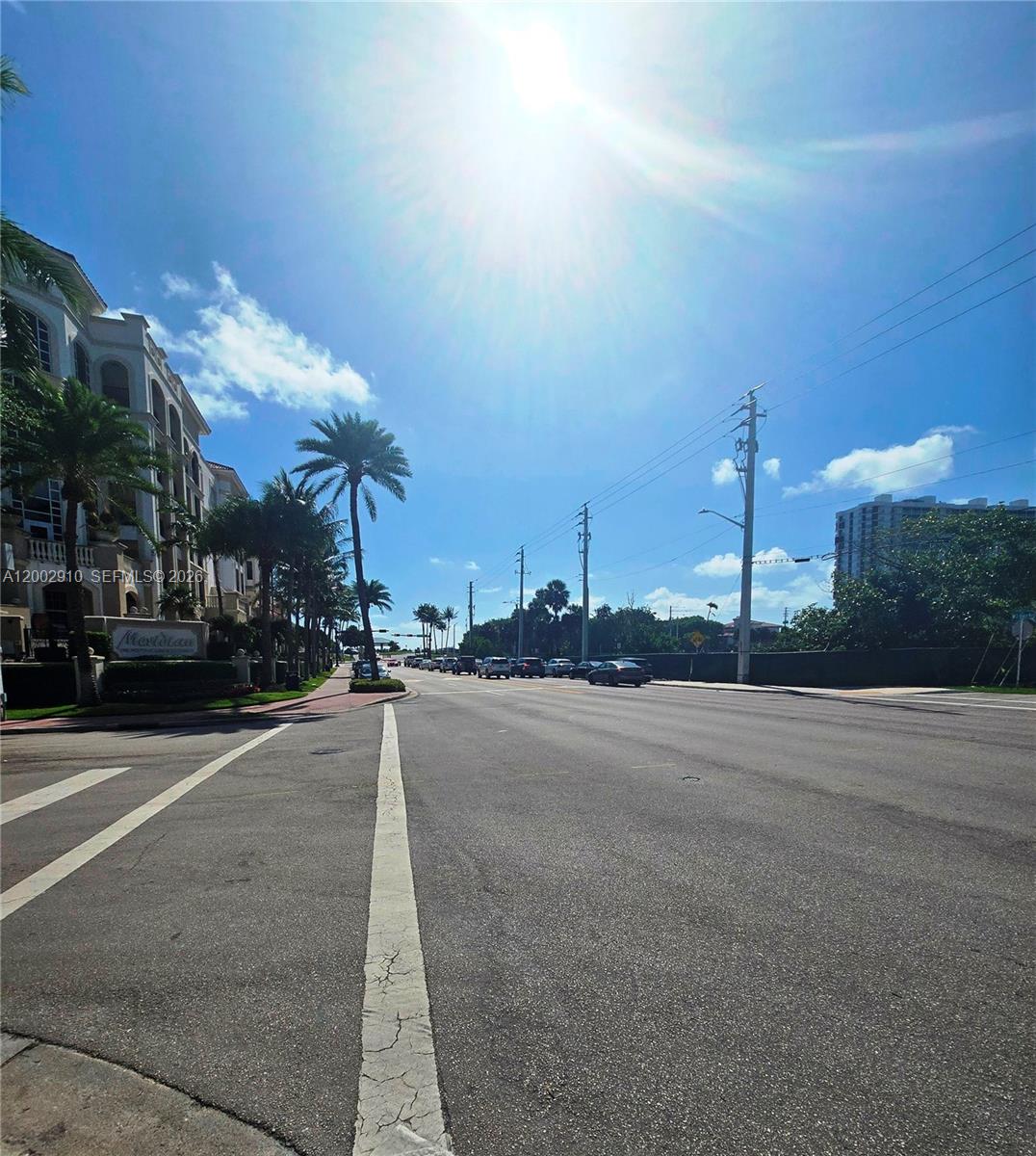 A street view shows a multi-story building with palm trees and utility poles under a sunny sky — 899 E PALMETTO PARK RD, Boca Raton FL 33432, BOCA RATON, FL