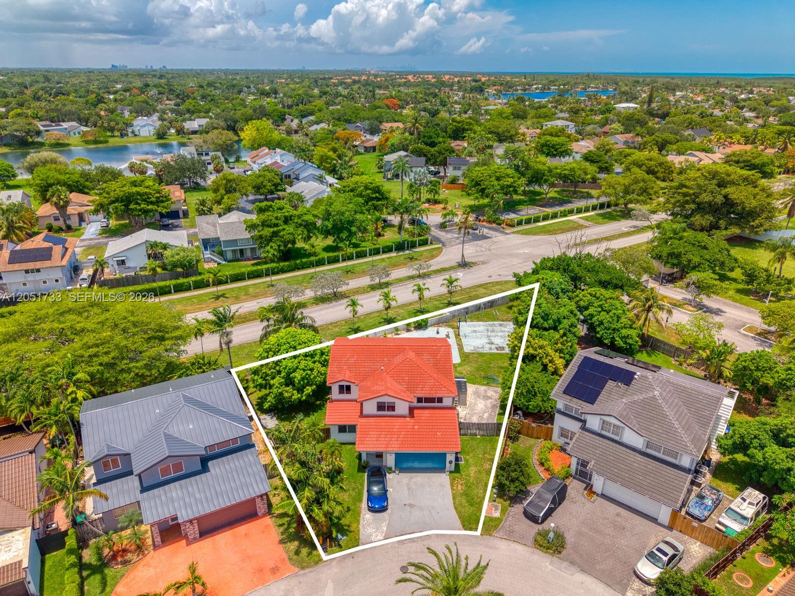 An aerial view shows a two-story house with a red tile roof and driveway — 8611 SW 207th Ter, Cutler Bay FL 33189, CUTLER BAY, FL