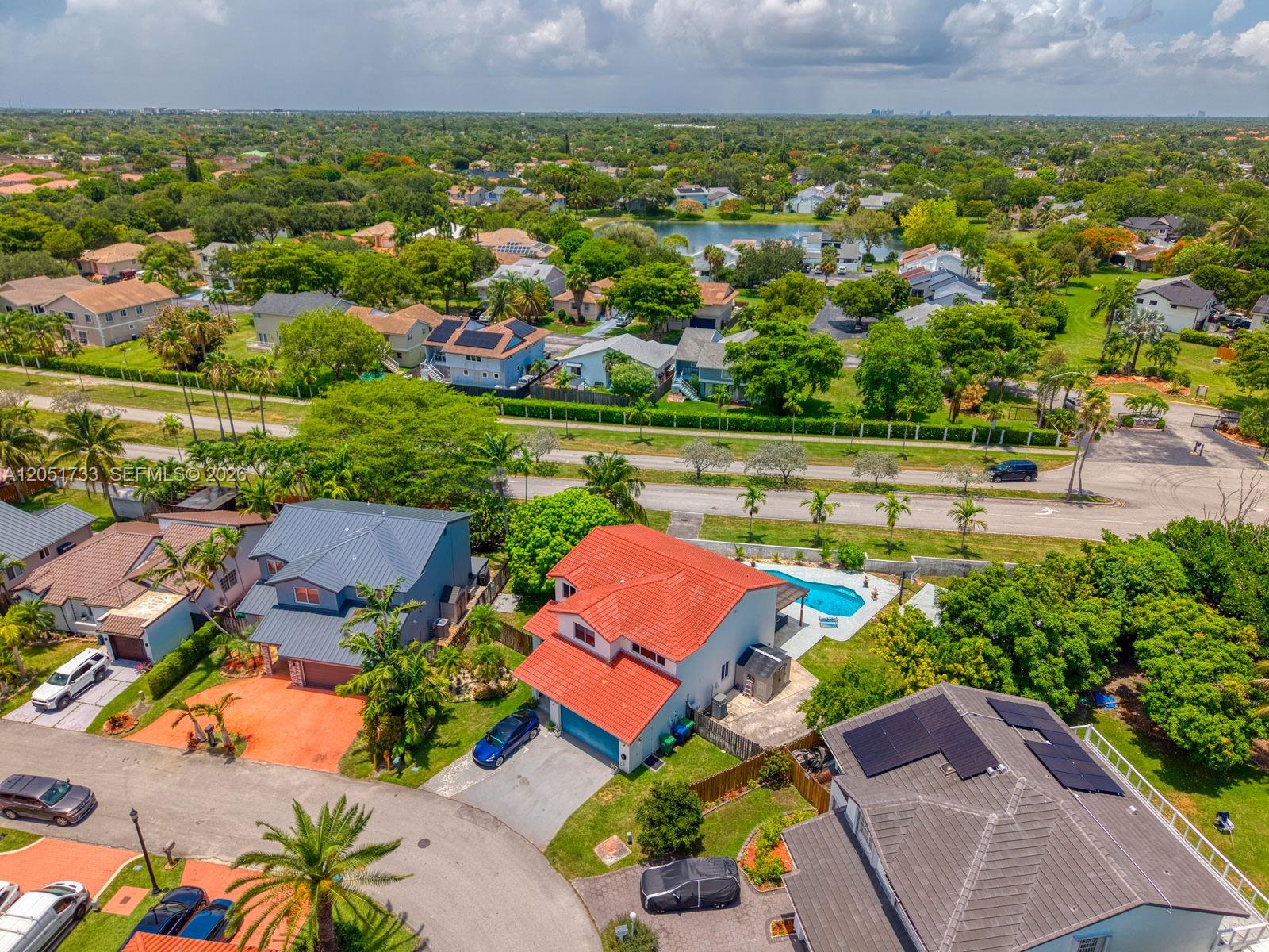 An aerial view shows suburban homes with pools, driveways, and lush green landscaping — 8611 SW 207th Ter, Cutler Bay FL 33189, CUTLER BAY, FL