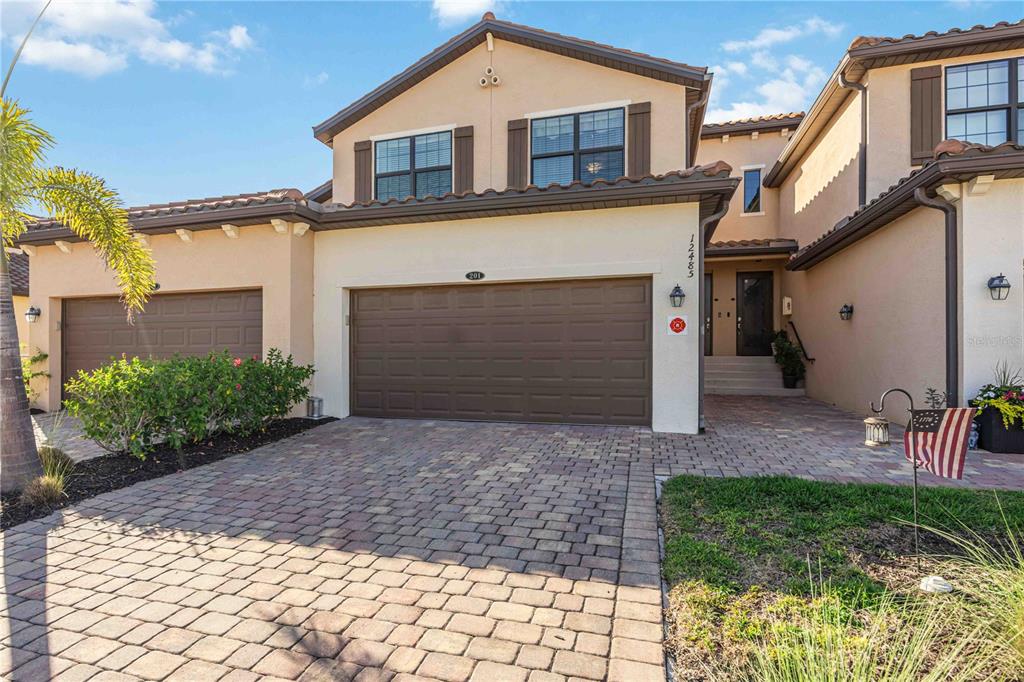 A two-story stucco house with a two-car garage and a paved driveway — 12485 GHIBERTI CIRCLE UNIT 201, VENICE, FL