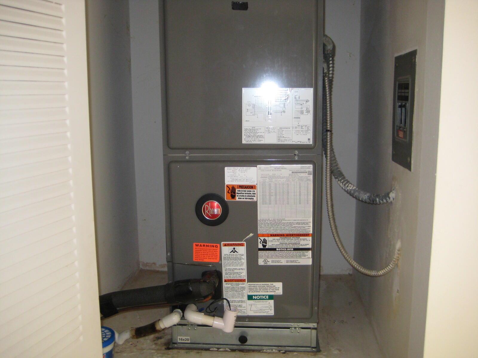 A Rheem HVAC unit sits inside a utility closet with a visible air filter slot — 5153 Oak Hill Road # 511, Delray Beach FL 33484, DELRAY BEACH, FL