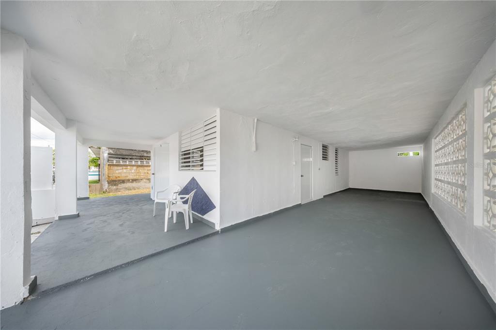 A covered outdoor patio or carport with gray painted floors and white walls — G4 AVENIDA A, FAJARDO, PR