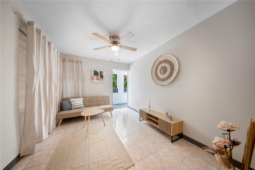 A living room features a beige sofa, a wooden coffee table, and a media console — G4 AVENIDA A, FAJARDO, PR