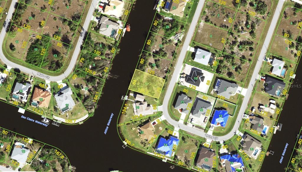 This is an aerial map showing residential lots, streets, and waterways in a suburban neighborhood — 9598 SPRING CIRCLE, PORT CHARLOTTE, FL