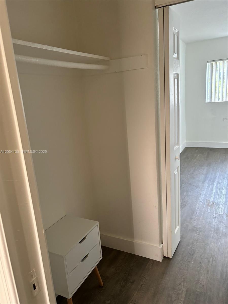 A small closet with a white shelf and a white two-drawer chest inside — 7701 SW 88th St # B224, Miami FL 33156, MIAMI, FL