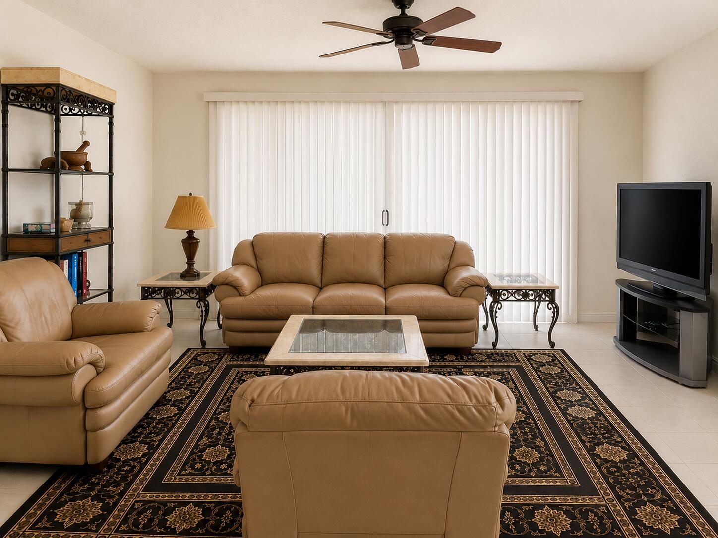 A living room features tan leather furniture, a glass-topped coffee table, and a patterned area rug — 7775 YARDLEY Drive # 115, Tamarac FL 33321, TAMARAC, FL