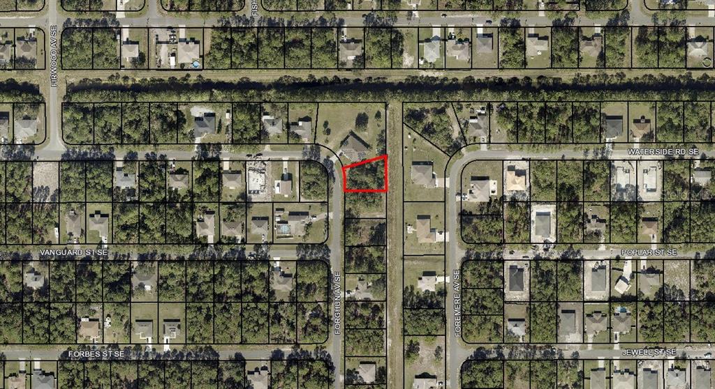 This is an aerial map showing a vacant lot outlined in red within a residential neighborhood — 3011 FORGHUN AVENUE SE, PALM BAY, FL
