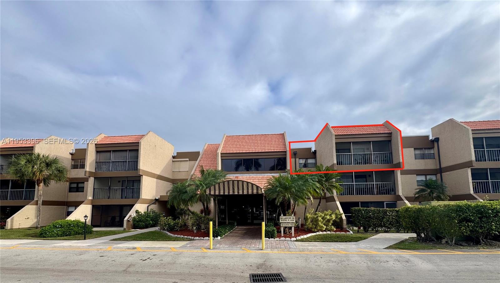 The exterior of a multi-story residential building features a highlighted top-floor balcony — 240 Lakeview Dr # 308, Weston FL 33326, WESTON, FL
