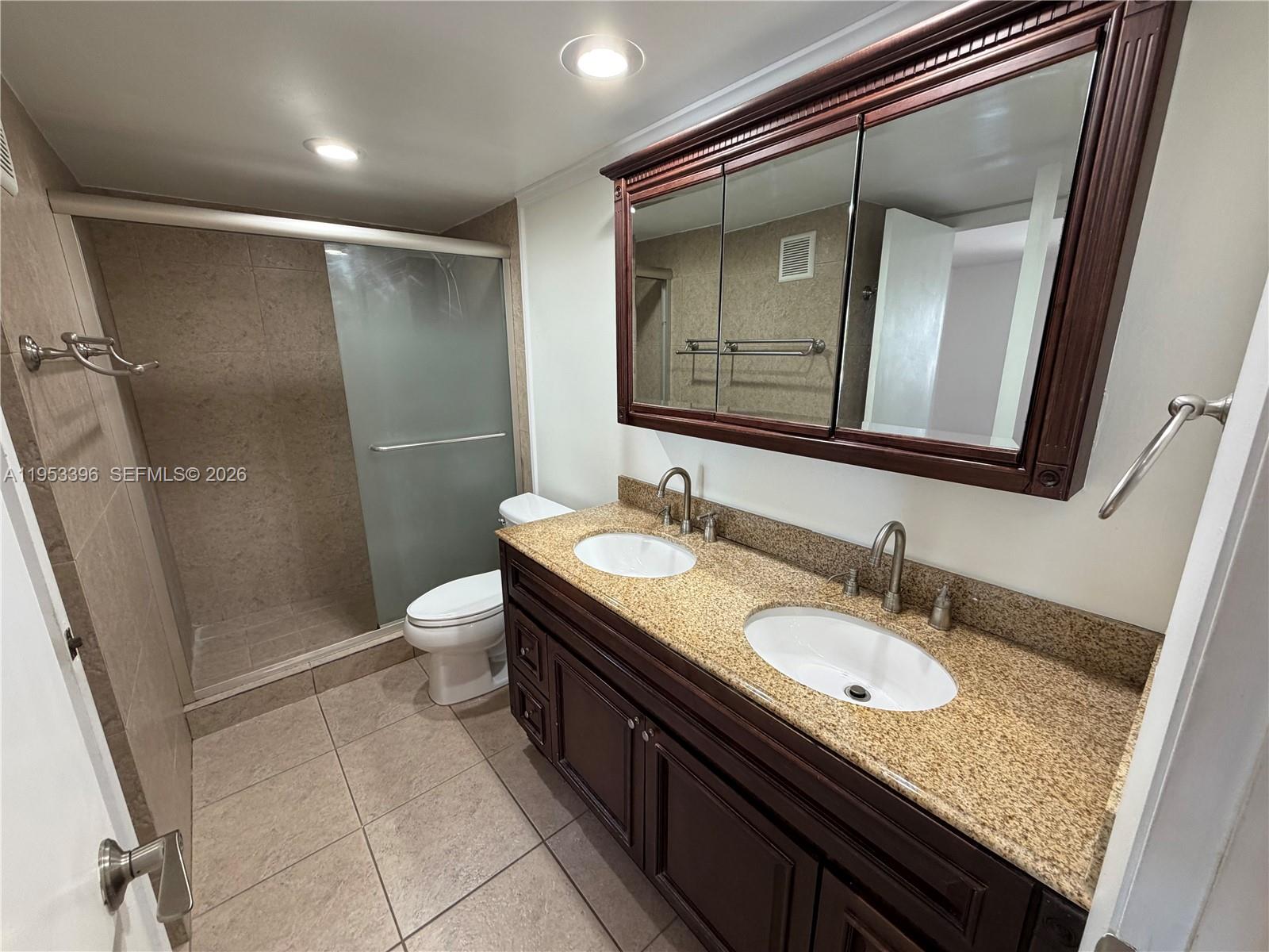 A bathroom features a double vanity with granite countertops, dark wood cabinets, and a walk-in shower — 240 Lakeview Dr # 308, Weston FL 33326, WESTON, FL