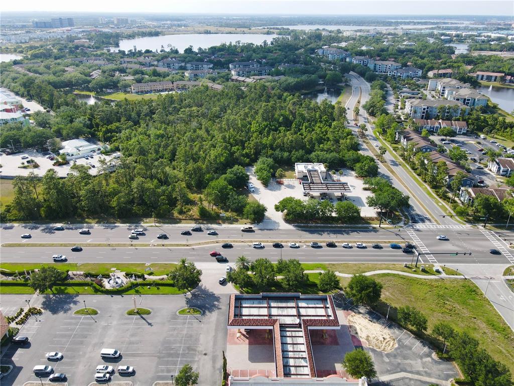 An aerial view shows a gas station, a large parking lot, and a multi-lane road — 11914 INTERNATIONAL DRIVE, ORLANDO, FL