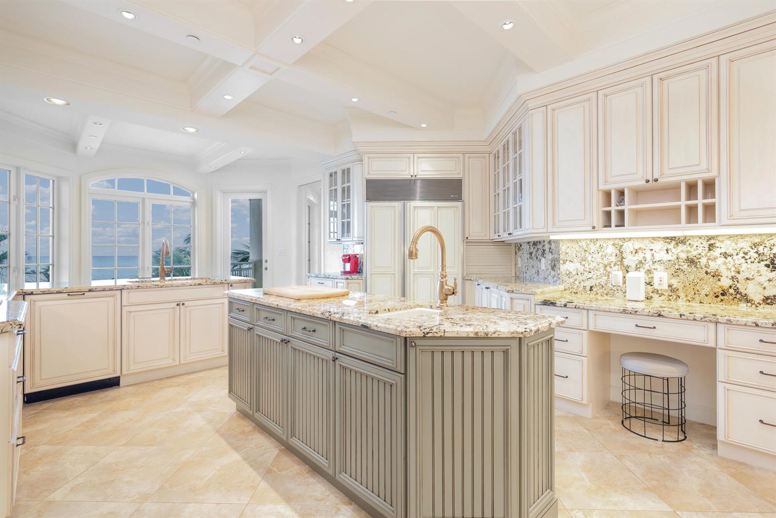 A kitchen with cream cabinets, a gray island, granite countertops, and a view of the ocean — 120 Jupiter Key Road # 4, Jupiter FL 33477, JUPITER, FL