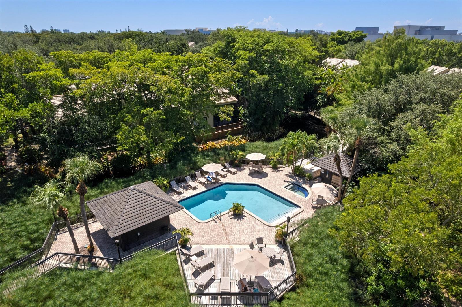 An aerial view of a swimming pool and hot tub surrounded by trees and decking — 793 Saint Albans Drive, Boca Raton FL 33486, BOCA RATON, FL