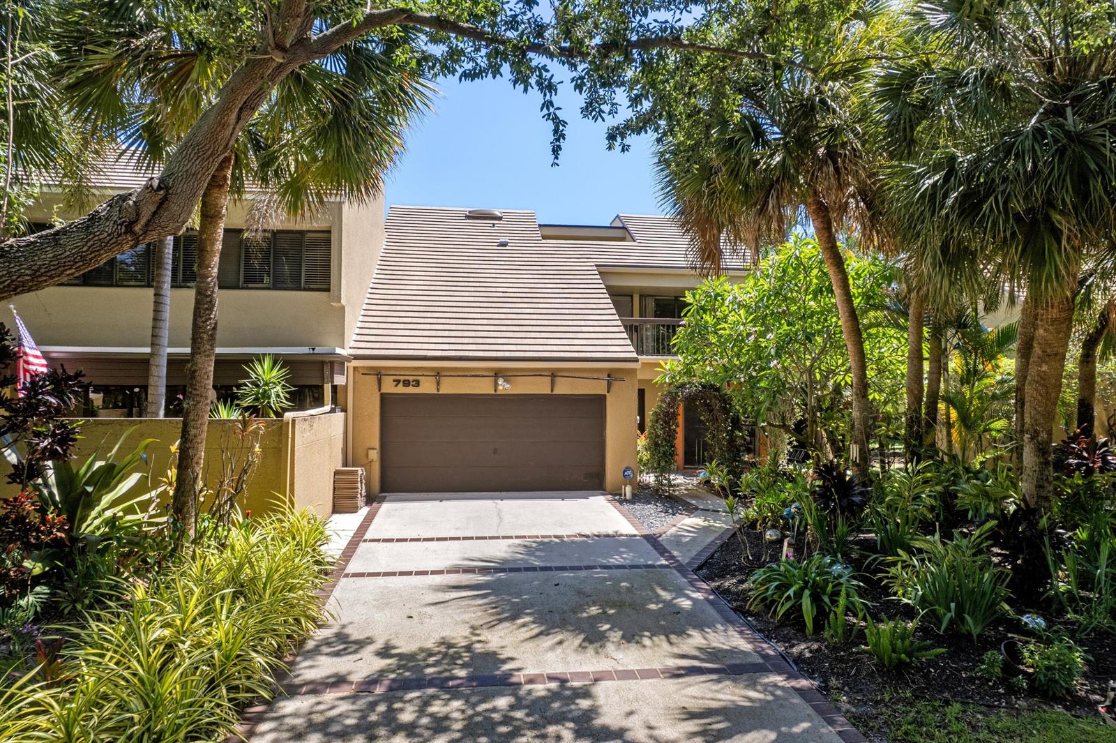 A two-story house with a brown garage door, a concrete driveway, and lush tropical landscaping — 793 Saint Albans Drive, Boca Raton FL 33486, BOCA RATON, FL