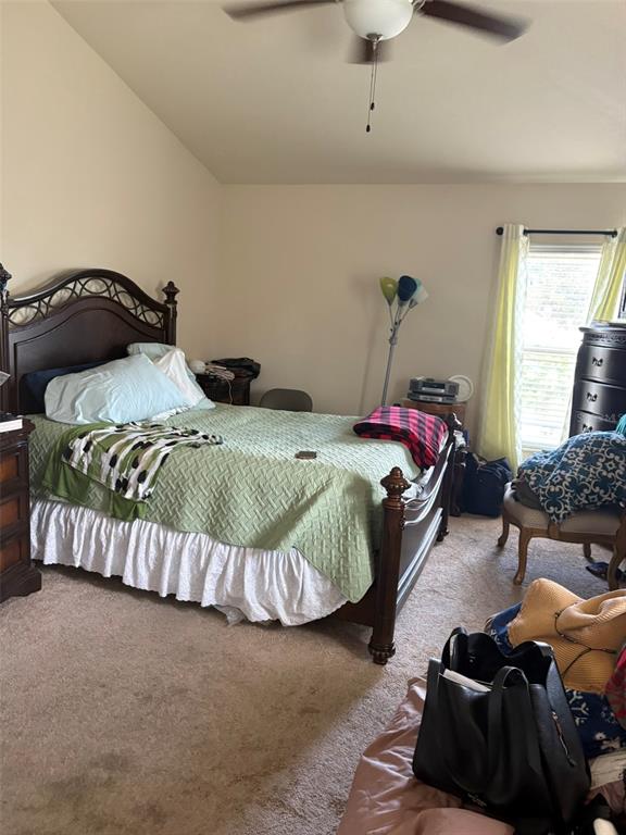 A bedroom features a dark wood bed frame, a green quilt, and a window with curtains — 1131 ALLEGRO PLACE, DUNDEE, FL