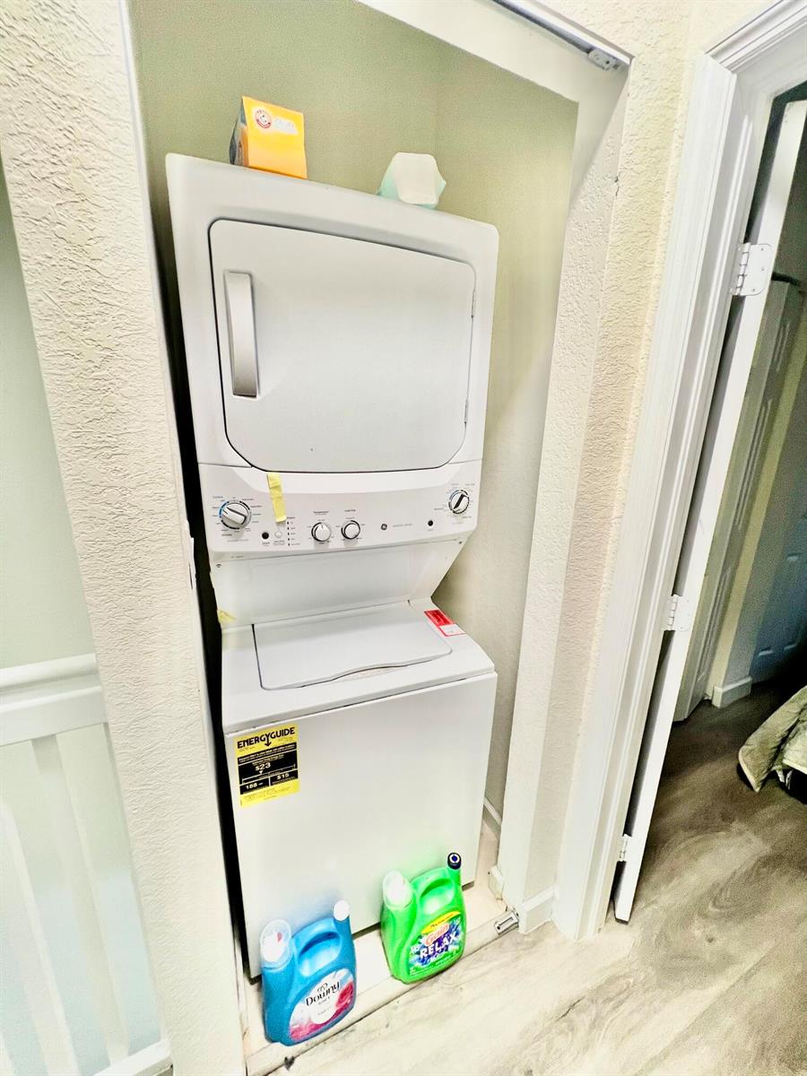 A stacked washer and dryer unit is located in a small laundry closet — 10490 W 33rd Way, Hialeah FL 33018, HIALEAH, FL