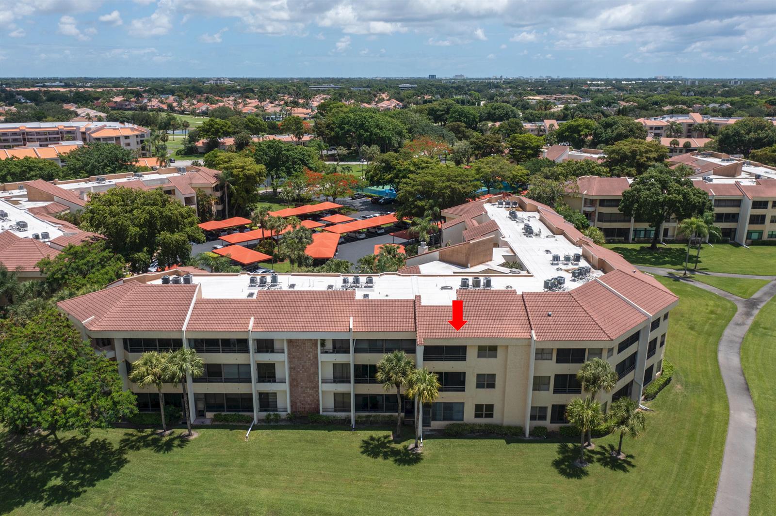 An aerial view of a multi-story residential building with a red tile roof — 7520 La Paz Boulevard # 104, Boca Raton FL 33433, BOCA RATON, FL