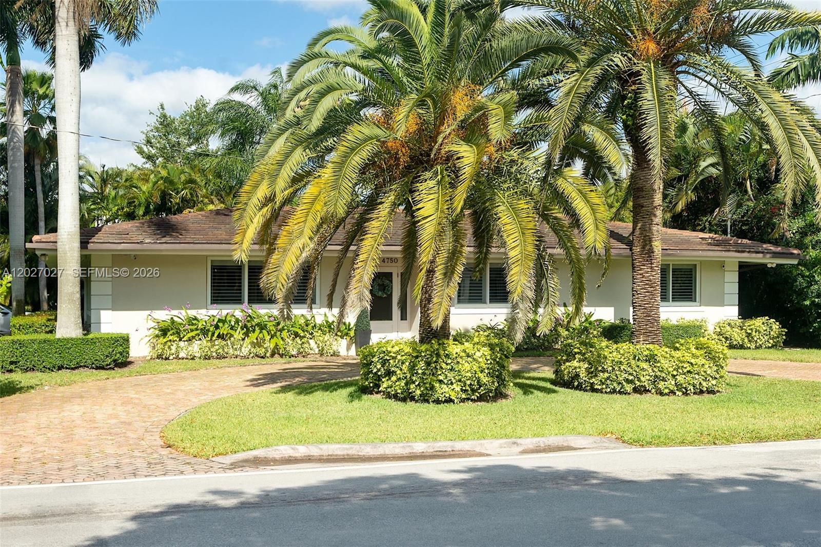 A single-story house with a brick driveway and palm trees in the front yard — 4750 Alhambra Cir, Coral Gables FL 33146, CORAL GABLES, FL