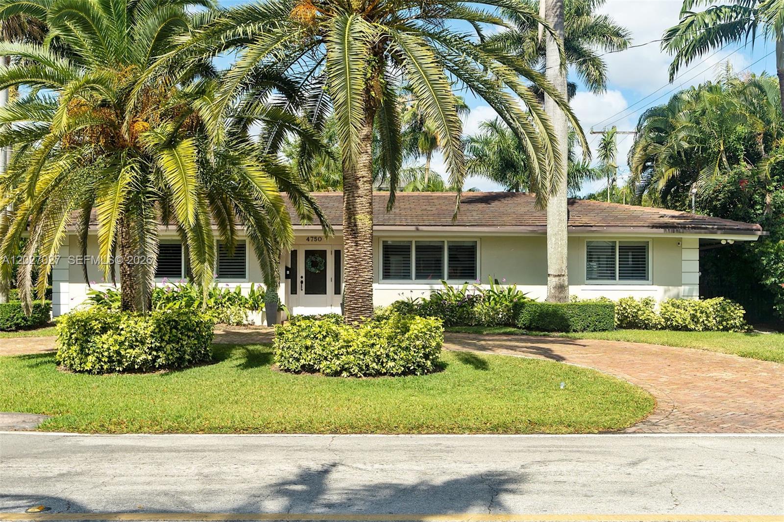 A single-story house with a brick driveway and palm trees in the front yard — 4750 Alhambra Cir, Coral Gables FL 33146, CORAL GABLES, FL