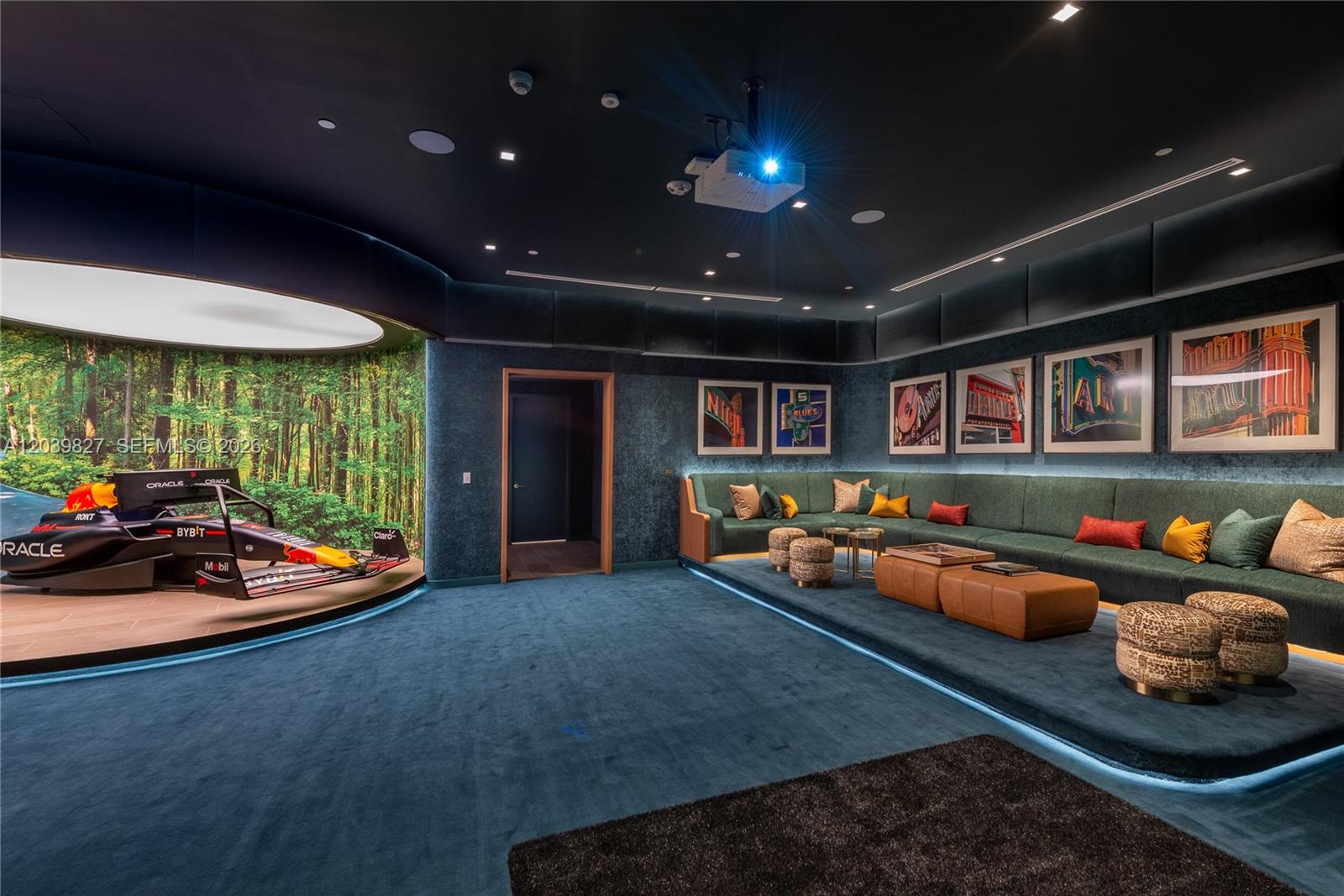 A media room features a Formula 1 car display, tiered seating, and dark blue carpeting — 77 SE 5th St # 3206, Miami FL 33131, MIAMI, FL