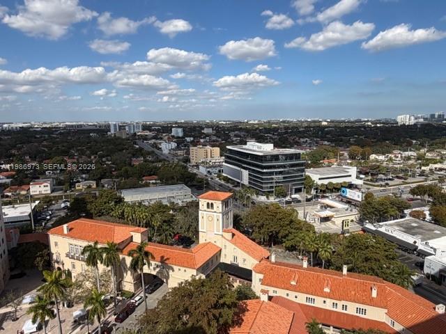 An aerial view shows a Mediterranean-style building with a tower and red tile roofs — 888 S Douglas Rd, Coral Gables FL 33134, CORAL GABLES, FL