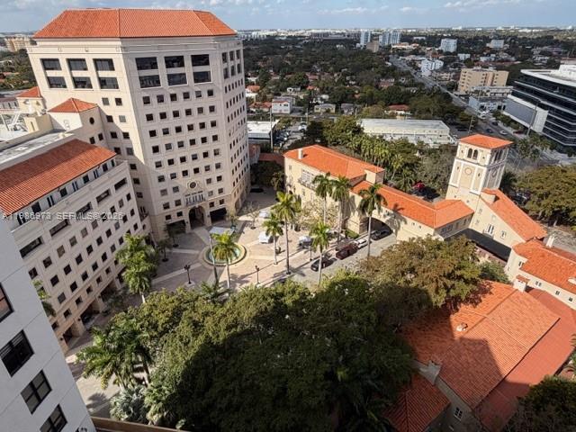 An aerial view shows a multi-story building complex with terracotta roofs and a central courtyard — 888 S Douglas Rd, Coral Gables FL 33134, CORAL GABLES, FL