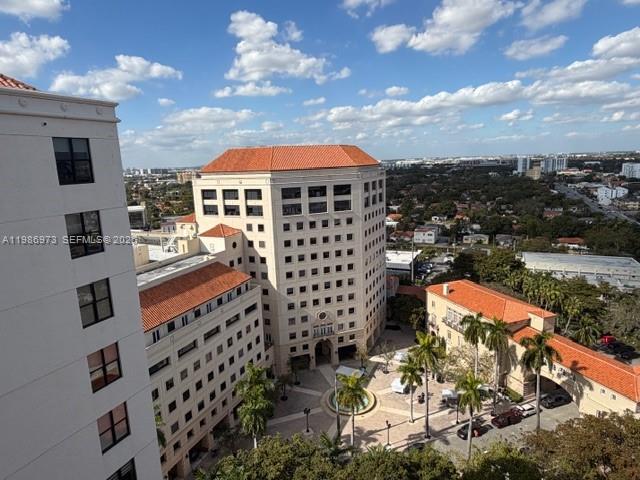 An elevated view of a multi-story building complex with a central courtyard and palm trees — 888 S Douglas Rd, Coral Gables FL 33134, CORAL GABLES, FL