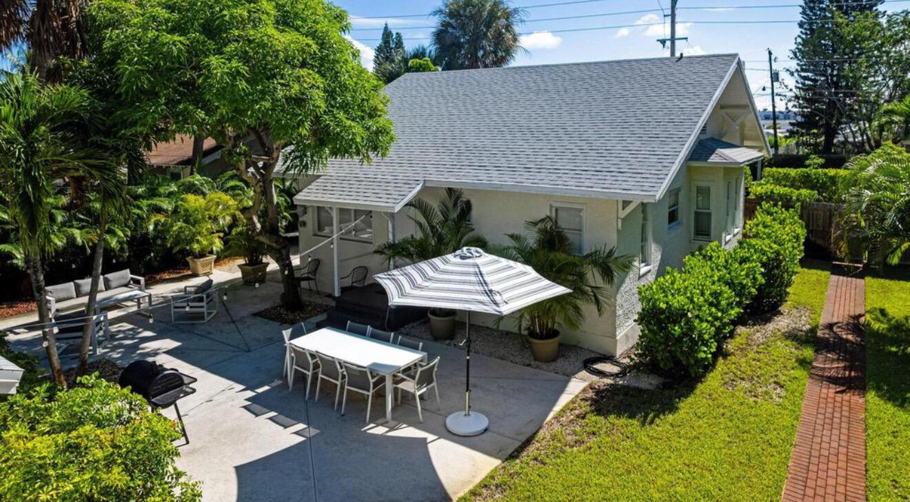 An aerial view of a house exterior featuring a patio, dining set, and umbrella — 5301 N Flagler Drive, West Palm Beach FL 33407, WEST PALM BEACH, FL