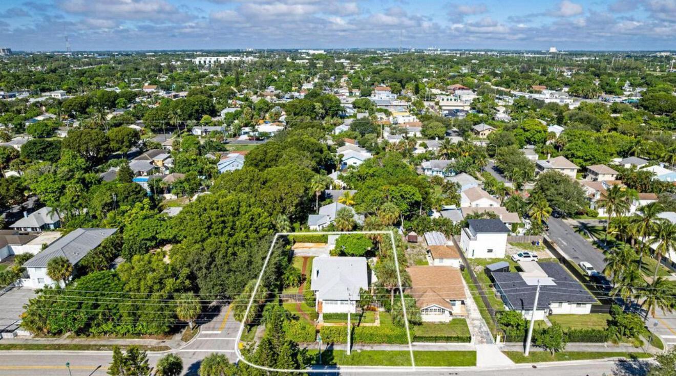 An aerial view shows a residential house with a white roof surrounded by lush trees — 5301 N Flagler Drive, West Palm Beach FL 33407, WEST PALM BEACH, FL