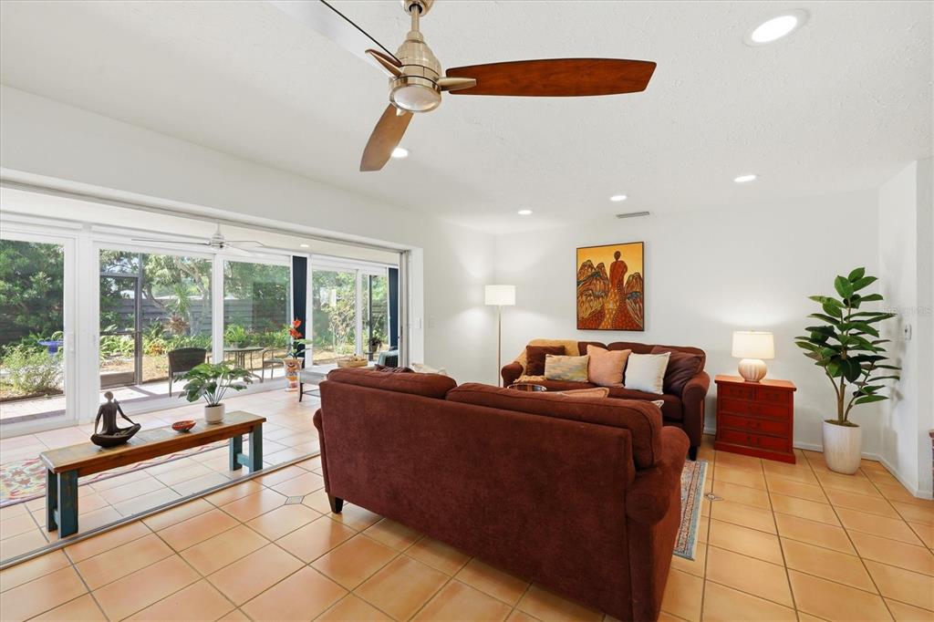 A living room features tile floors, a ceiling fan, and sliding glass doors to a patio — 3504 BROOKLINE DRIVE, SARASOTA, FL