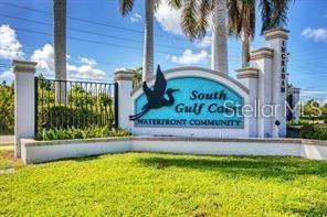 A sign for South Gulf Cove waterfront community stands in front of palm trees — 15674 MARGO CIRCLE, PORT CHARLOTTE, FL