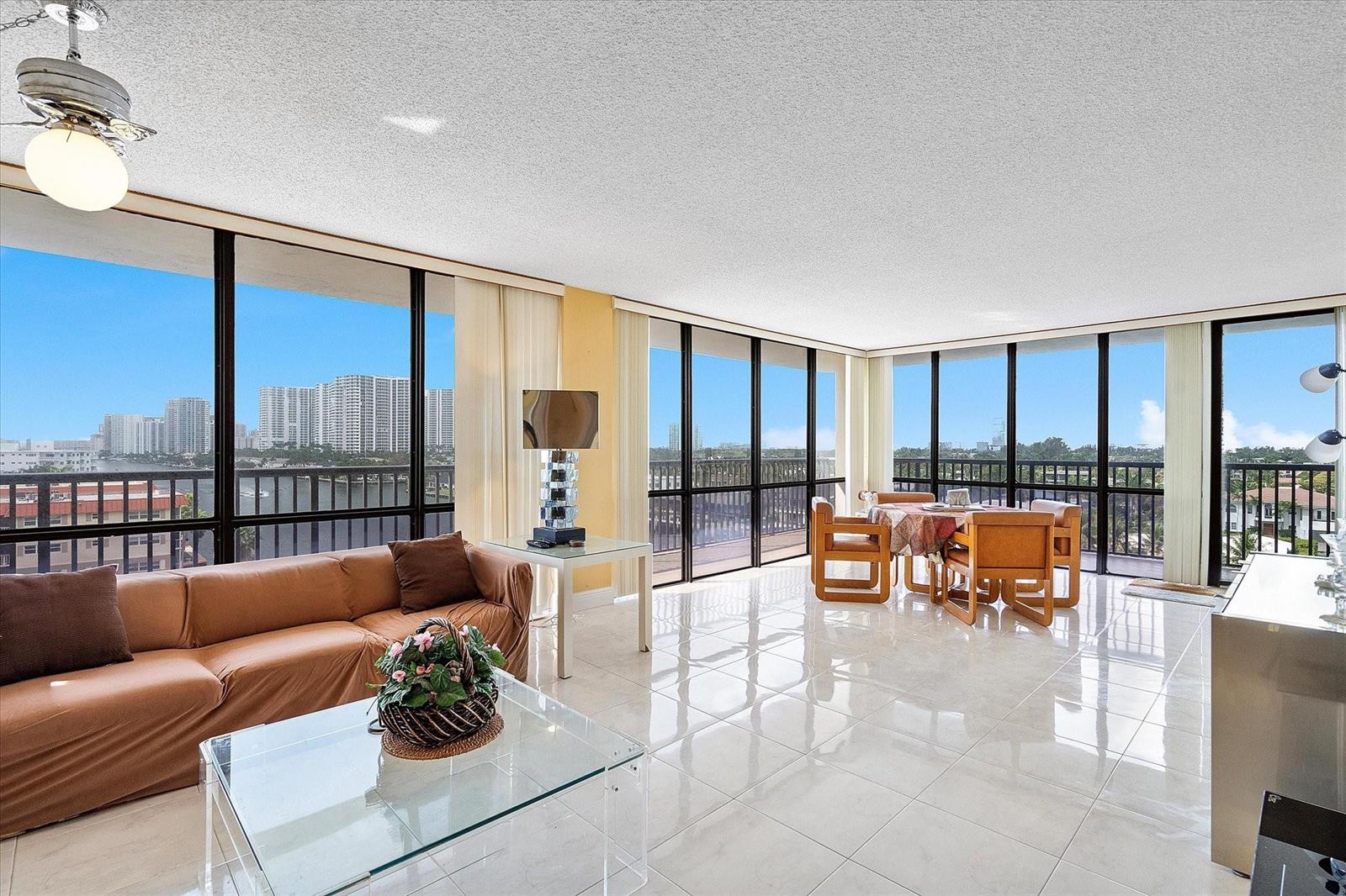 A living and dining area with tile floors, floor-to-ceiling windows, and a water view — 2017 S Ocean Drive # 710, Hallandale Beach FL 33009, HALLANDALE BEACH, FL